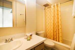 Full bathroom with tub and shower combo.