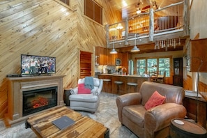 Kitchen and dining area open to the living room with loft above