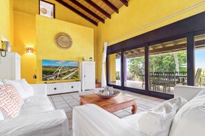 Spacious living room with smart TV and sliding doors to patio (1)
