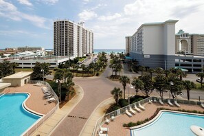Private balcony views of the common grounds and beach