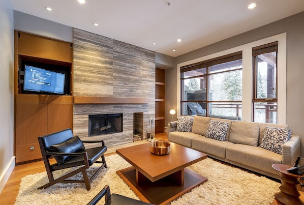 Living Room with wood burning fireplace and TV