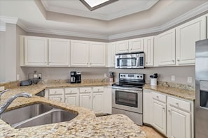 The Fully Equipped, Spacious Kitchen has Stainless Steel Appliances and Granite Counter Tops