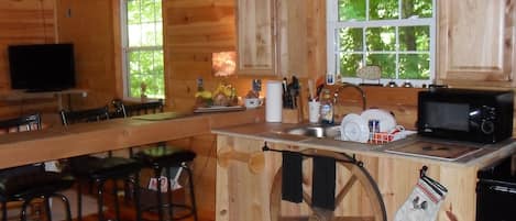 view of kitchen with stone counter tops and bar, ponderosa pine interior.