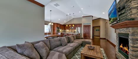 Living room with sectional couch, HDTV connected to Charter Cable, Yamaha sound bar, and gas fireplace