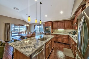 Kitchen with double electric oven, gas range cooktop, French door refrigerator with ice maker, dishwasher, microwave, Keurig coffee maker, coffee press, Soda Stream, and more