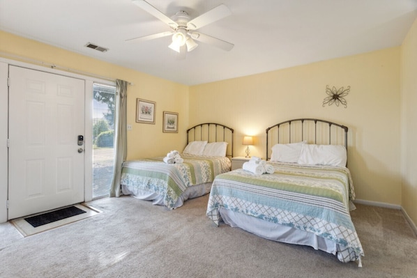 Once you enter the home, you'll see this bedroom with two full beds, laundry, and plenty of storage.