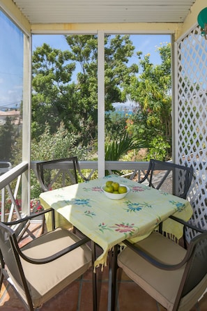 dining table on screen  porch with ocean views and breeze