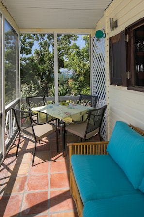 continue on to screen porch with sofa and 4 place table. enjoy the breeze.