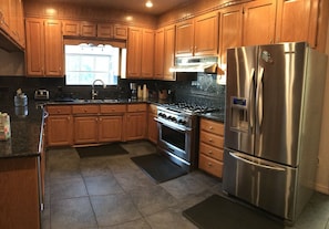 Fully equipped kitchen with bar and eating area. 