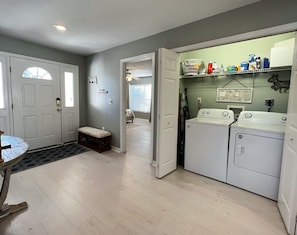 View of the front entry door and full sized washer and dryer clo - View of the front entry door and full sized washer and dryer closet inside the unit