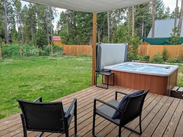 Fully fenced in backyard with hot tub, BBQ and fireplace 