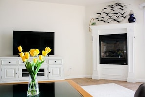 Living room equipped with gas fire place and modern TV