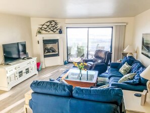 The living room space with a deck that showcases the ocean