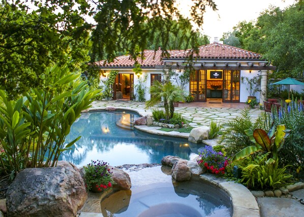 View of the spa, pool, and cabana exterior