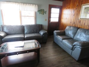Living room has all leather furniture 