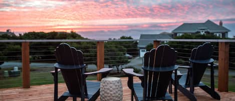 Sunset from large upper deck facing the white waters of the Pacific. 