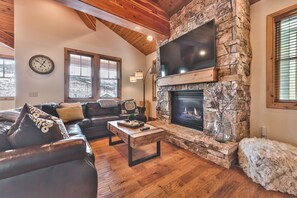 Living Room with Comfortable Sectional Sofa, 60" Smart TV, and Gas Fireplace