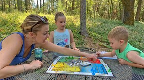 Family Fun! - Enjoying a board game outdoors on the backyard patio table.