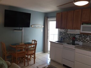 50" TV, kitchen &amp; door to balcony