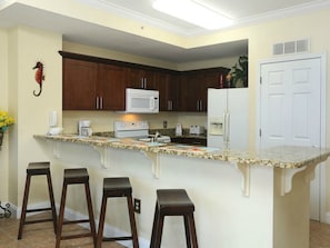 The kitchen bar stools, which can seat four people comfortably.