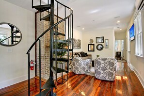 Spiral staircase leads to upstairs bathroom and 3 bedrooms
