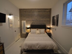Downstairs- Custom wood slatted wall.