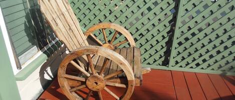 Wagon wheel chair on deck in front of the apartment.