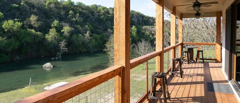 Top deck with a table for 2 and other stools to sit and enjoy the lovely view!