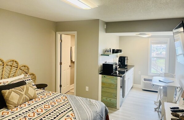 This studio condo is furnished with a queen bed, futon, and a flat screen tv.