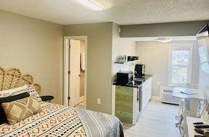 This studio condo is furnished with a queen bed, futon, and a flat screen tv.