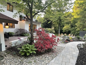 Lush lawn and gardens surround the house