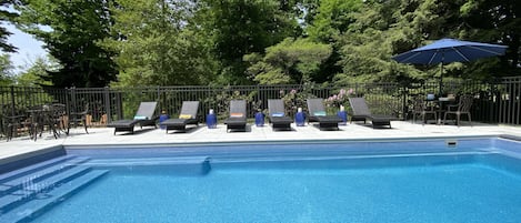 Heated, fenced, covered pool with seating ledges