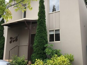 Front facade of apartment, with parking for two vehicles