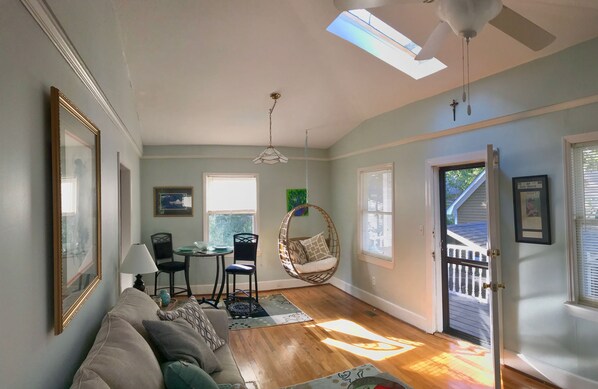 panning from front door to Spacious living area below vaulted ceiling &skylight.