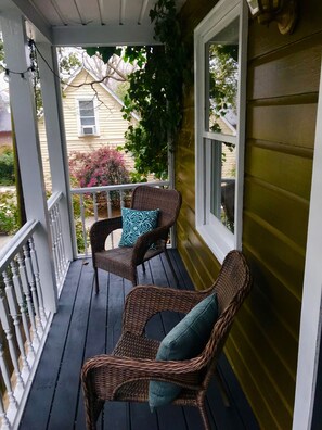 Rain or shine, New Orleans front porch always beckons you to relax