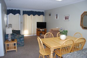 Living/Dining area with screened patio facing ocean and beach
