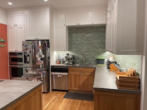 In 2021, our kitchen and dining room was just renovated down to the studs.  It has a new, modern, open feel, yet still retains the style and charm of an old Edwardian.  We have a fully-stocked kitchen, with brand new stove, oven, fridge, and high-end cabinets. 