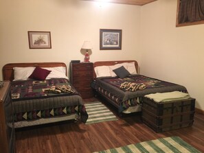 Lodge bedroom has 2 queen beds, access to the patio, and it’s own bathroom. 