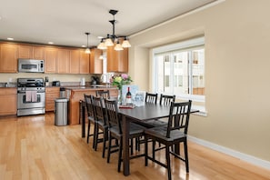 The dining table is set up for 8, with capacity to accommodate even more