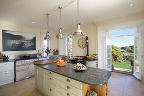 Kitchen with french doors to the garden and outdoor seating area. 