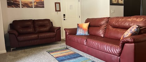 Enjoy your home away from home. Comfortable living room with Sofas and TV.