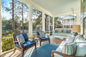 Screened-in porch with cushioned seating