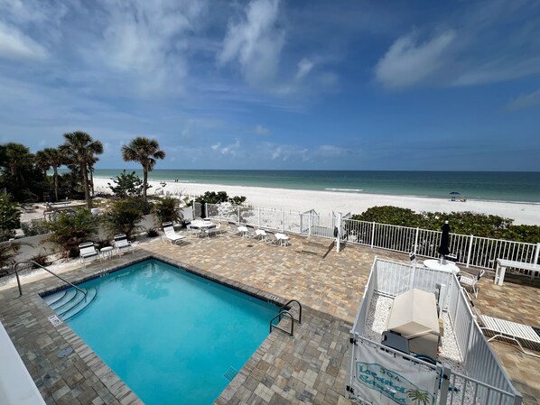 View from your private balcony overlooking the new sundeck, heat - View from your private balcony overlooking the new sundeck, heated pool, and Indian Rocks Beach