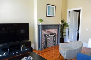 Original brick fireplace ( non-working) with iron insert