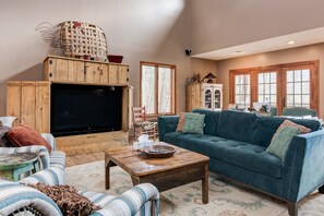 60" HD TV with Blu-Ray and surround sound in living room.
