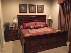 Custom bedding and drapes on king-sized bed in Master bedroom