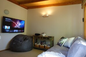 Media room with Netflix, Disney+, PrimeVideo and gigantic couples beanbag. 