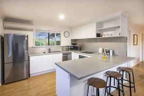 New kitchen with 2 door fridge, dishwasher, microwave and Nespresso pod machine