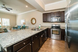 Fully equipped kitchen with stainless steel appliances and granite counters