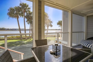 The screened porch has glorious views of the river and a dining table that seats 4.